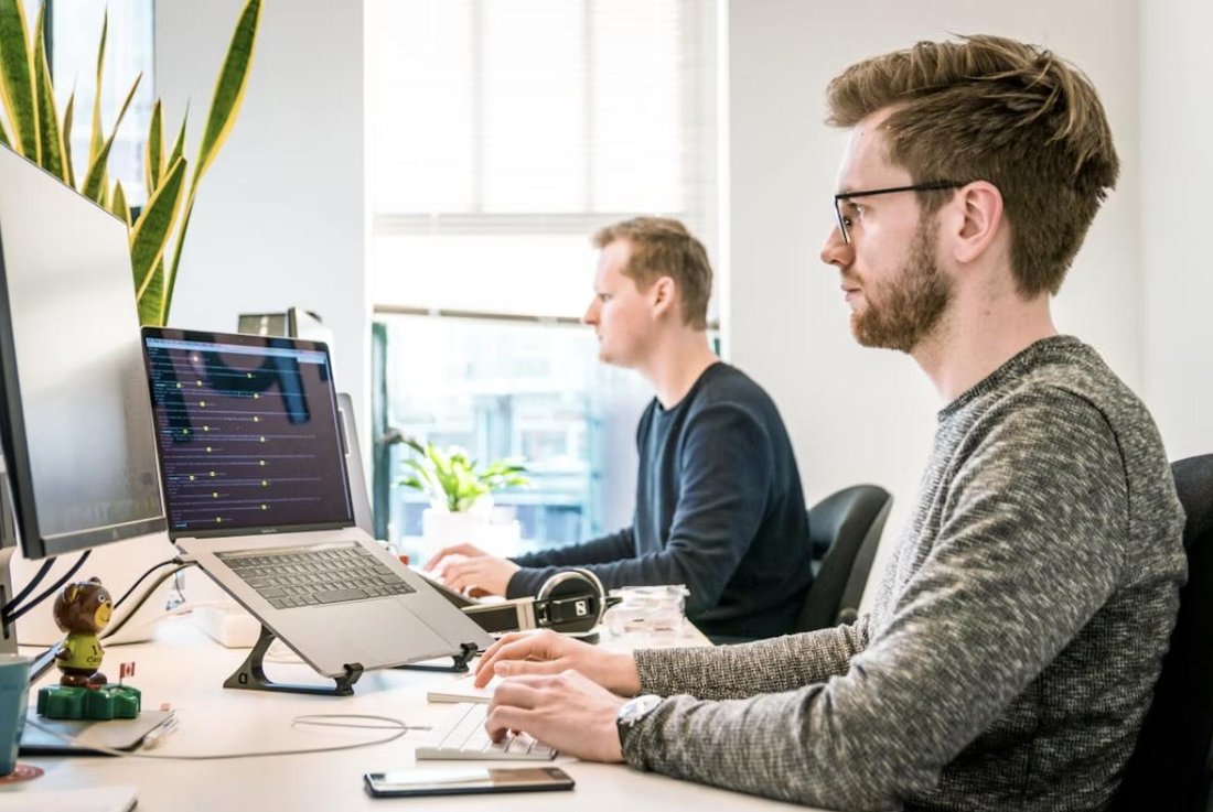 Engineer working at a multi-monitor workstation